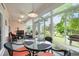 Bright sunroom features table for four and backyard access at 1433 Beaumont Way, Myrtle Beach, SC 29577