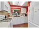 White kitchen with stainless steel appliances and a view to dining area at 4396 Baldwin Ave. # 109, Little River, SC 29566