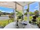 Bright screened porch with outdoor seating and beautiful views at 242 Sun Colony Blvd. # 101, Longs, SC 29568