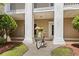 Inviting building exterior with a bike and lush landscaping at 242 Sun Colony Blvd. # 101, Longs, SC 29568