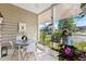 Charming screened porch with a bistro set and lush greenery at 242 Sun Colony Blvd. # 101, Longs, SC 29568