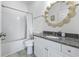 Clean bathroom with a shower/tub combo, granite vanity, and decorative mirror at 242 Sun Colony Blvd. # 101, Longs, SC 29568