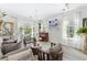 Bright living room with hardwood floors, comfy seating, and access to a patio at 242 Sun Colony Blvd. # 101, Longs, SC 29568