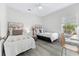 Spacious bedroom with two twin beds, a workspace, and plenty of natural light at 242 Sun Colony Blvd. # 101, Longs, SC 29568