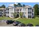 Two-story building with ample parking, providing convenient access to apartments at 242 Sun Colony Blvd. # 101, Longs, SC 29568