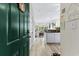 Green door entryway opening to living area and kitchen at 242 Sun Colony Blvd. # 101, Longs, SC 29568