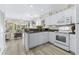 White kitchen with granite countertops and appliances at 242 Sun Colony Blvd. # 101, Longs, SC 29568