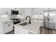 Modern kitchen features stainless steel appliances and an island with a quartz countertop at 132 Oak Bay Dr., Georgetown, SC 29440