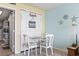 Small dining area with white table and chairs, beach-themed decor at 2801 S Ocean Blvd. # 1838, North Myrtle Beach, SC 29582