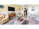 Bright living room with comfy seating, a large TV, and coastal decor at 2801 S Ocean Blvd. # 1838, North Myrtle Beach, SC 29582