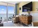 Living room with ocean view and wooden dresser at 2801 S Ocean Blvd. # 1838, North Myrtle Beach, SC 29582