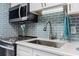Modern kitchen with stainless steel appliances and light blue tile backsplash at 2801 S Ocean Blvd. # 1838, North Myrtle Beach, SC 29582