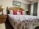 King-size bed with floral bedding and wooden nightstands at 1401 S Ocean Blvd. # 1001, North Myrtle Beach, SC 29582