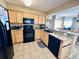 Modern kitchen with granite countertops and black appliances at 1401 S Ocean Blvd. # 1001, North Myrtle Beach, SC 29582