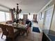 Bright dining room with glass table and wicker chairs, near kitchen at 1401 S Ocean Blvd. # 1001, North Myrtle Beach, SC 29582