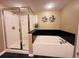 Bathroom with a shower and a large bathtub at 1401 S Ocean Blvd. # 1001, North Myrtle Beach, SC 29582