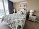 Bedroom with a queen bed, nightstands, and ocean view at 1401 S Ocean Blvd. # 1001, North Myrtle Beach, SC 29582