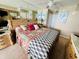 King-size bed, wicker furniture, and tropical art in a condo bedroom at 1401 S Ocean Blvd. # 1001, North Myrtle Beach, SC 29582