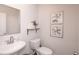 Small powder room with pedestal sink and toilet at 7089 Watercress St, Myrtle Beach, SC 29579
