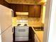 Small kitchen with wood cabinets, stove, and refrigerator at 150 Wedgefield Village Rd. # 24, Georgetown, SC 29440