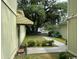 Side yard with a walkway, landscaping, and a partial view of the street at 150 Wedgefield Village Rd. # 24, Georgetown, SC 29440