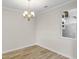 Empty dining room with chandelier and hardwood floors, ready for your furniture at 614 Castle Ct., Myrtle Beach, SC 29579