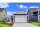 Two-car garage with white door and gray siding at 614 Castle Ct., Myrtle Beach, SC 29579