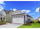 Two-car garage with white door and gray siding at 614 Castle Ct., Myrtle Beach, SC 29579