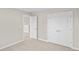 Empty bedroom with neutral walls, carpet, and double doors to a closet at 297 Broughton Dr., Myrtle Beach, SC 29579