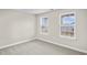 Simple bedroom with neutral walls and carpet, featuring two large windows at 297 Broughton Dr., Myrtle Beach, SC 29579