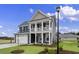 Two-story home with gray siding, white trim, and a two-car garage at 297 Broughton Dr., Myrtle Beach, SC 29579