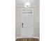 White front door with glass transom and updated hardware at 297 Broughton Dr., Myrtle Beach, SC 29579