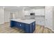 Modern kitchen features white cabinets, a blue island, and stainless steel appliances at 297 Broughton Dr., Myrtle Beach, SC 29579