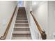 Elegant staircase with wood railings and carpeted steps at 297 Broughton Dr., Myrtle Beach, SC 29579