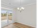 Dining room with chandelier, sliding glass door, and backyard view at 315 Broughton Dr., Myrtle Beach, SC 29579