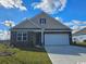 New construction home with stone accents and a two-car garage at 331 Clear Lake Dr., Conway, SC 29526