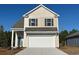 Two-story house with neutral siding, attached garage, and landscaping at 1127 Flintshire Dr., Myrtle Beach, SC 29579