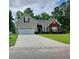 Tan brick house with a two-car garage and landscaping at 173 Rocko Dr., Myrtle Beach, SC 29579