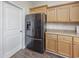 Sleek black refrigerator in a kitchen with wood cabinets at 268 Maple Oak Dr., Conway, SC 29526