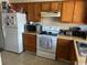Kitchen with wood cabinets, appliances, and tile floor at 1025 Carolina Rd. # M-3, Conway, SC 29526