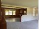 Bright dining area with wood paneling and a view into the kitchen at 4155 Pinewood Dr., Mullins, SC 29574