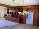 Open dining room with a chandelier, built-in shelves, and hardwood floors at 4155 Pinewood Dr., Mullins, SC 29574