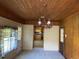 Dining room with wood paneling, carpeting, and a view of the kitchen at 4155 Pinewood Dr., Mullins, SC 29574
