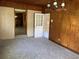 Dining area with wood paneling, carpet, and access to the outdoors at 4155 Pinewood Dr., Mullins, SC 29574