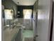 Bathroom with green tile, a shower/tub combo, and a vanity at 4155 Pinewood Dr., Mullins, SC 29574