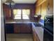 View of the kitchen with wood cabinets and a double sink at 4155 Pinewood Dr., Mullins, SC 29574