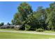 Brick house with mature trees and a large yard at 4155 Pinewood Dr., Mullins, SC 29574