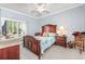 Bright bedroom with wood furniture and access to a private balcony at 1525 Lanterns Rest Rd. # 203, Myrtle Beach, SC 29579