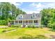 Charming white house with a large front porch and well-maintained lawn at 406 N Nichols St., Nichols, SC 29581