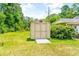 Tan colored storage shed with a small deck at 406 N Nichols St., Nichols, SC 29581
